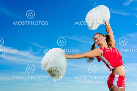 Young cheerleader in red costume with pampon