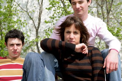 Moody teenagers posing with their father