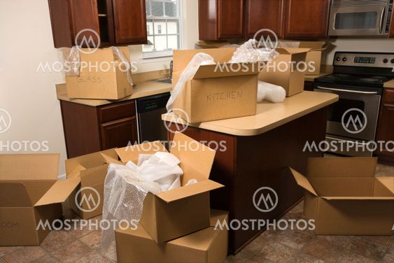 Moving boxes in kitchen.