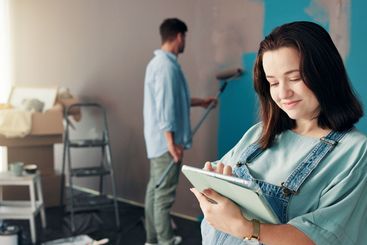 Couple, painting and woman in home on tablet for...