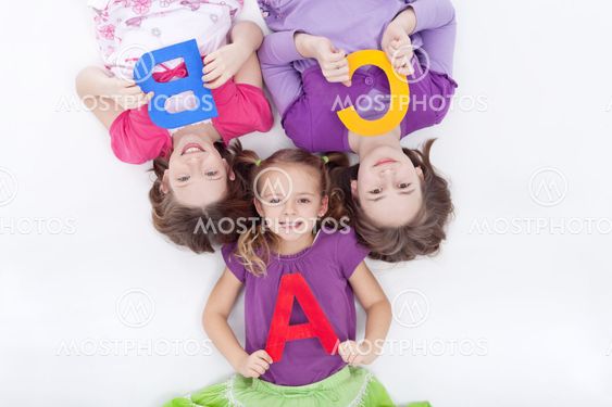 Girls holding A B C letters