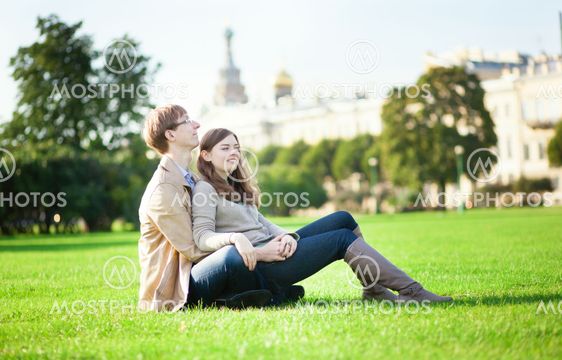 Couple citting on the grass in Saint-Petersburg, Russia