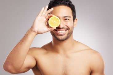 Beauty, lemon and portrait of man in studio for natural...
