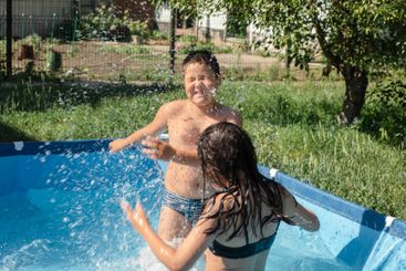 simple pleasures of childhood as two siblings laugh and...