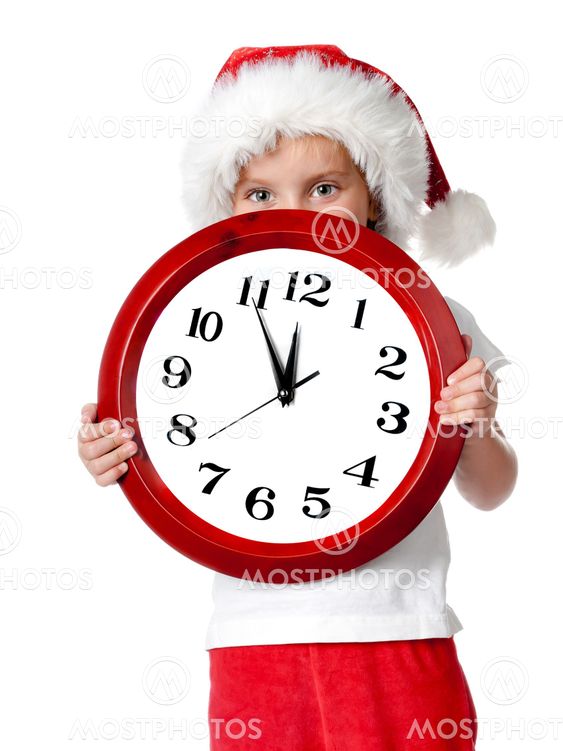 cute little girl in santa cap with a clock