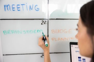 Female project manager planning work on project,...