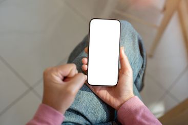 A close-up of a frustrated woman sitting indoors,...