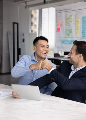 Two happy diverse business partners and friends enjoying...