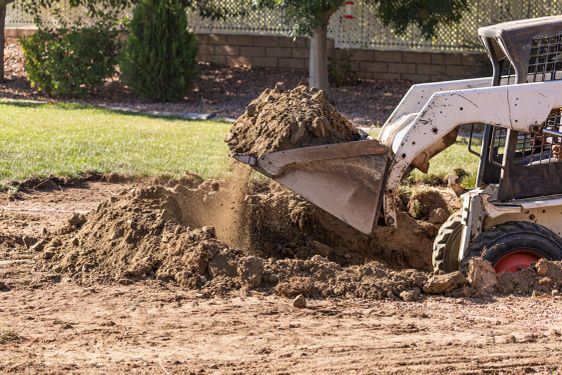 Small Bulldozer Digging In Yard For Pool Installation