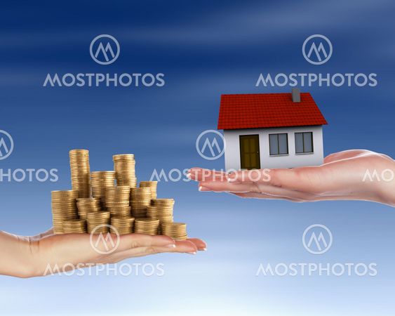 Human hands and house against blue sky