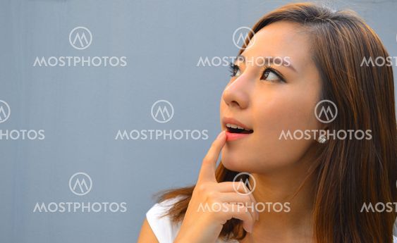 Beautiful young asian woman thinking