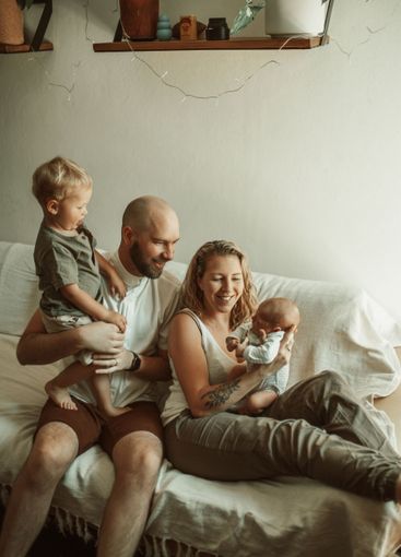 Happy family, bond and parents with baby and toddler on...