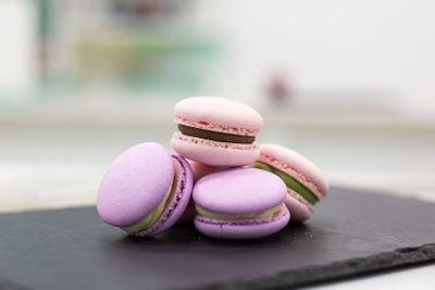 Colourful tasty macaroons on the black table