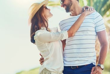 Couple, people and joy on hug in outdoor with sunglasses...