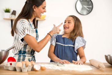Mother and daughter making a cake