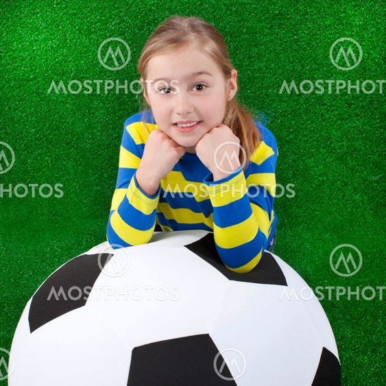 Young girl with huge soccer ball