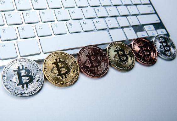 six coins of bitcoin on white laptop pc keyboard