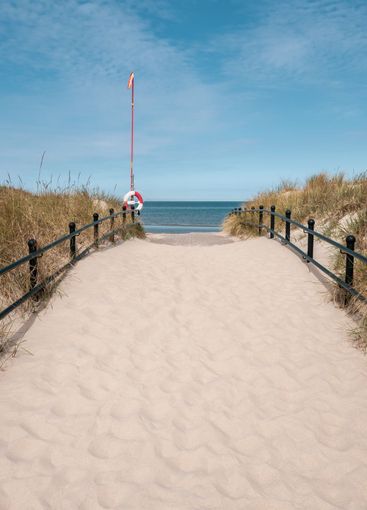 Pathway to a beautiful white sand beach in Skåne, Sweden.