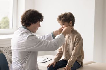 Young male doctor family therapist checking up sick...