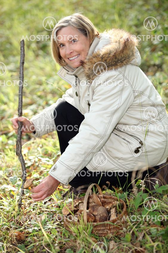 Woman collecting mushrooms in the forest