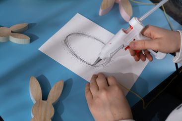 Creating Easter egg with cotton rope and colorful...