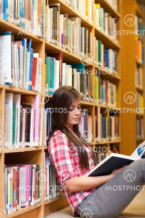 Portrait of a young female student reading a book