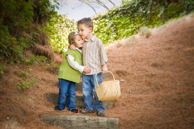 Two Children with Basket Hugging Outside on Steps