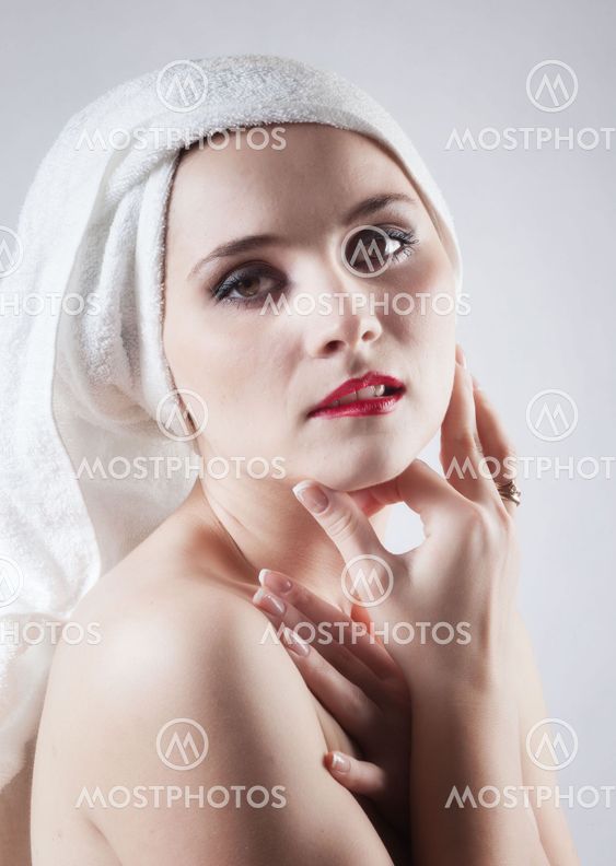 Young beautiful girl in the sauna towel