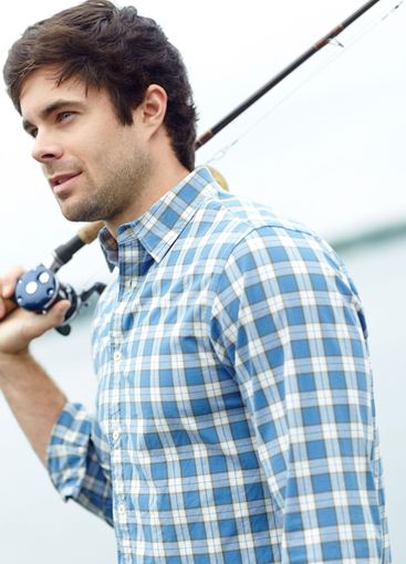 Travel, man and fishing rod at river for holiday,...