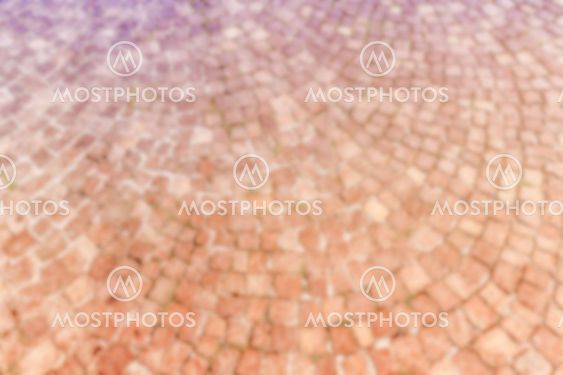 Defocused background of Sampietrini cobblestone pavement in Rome, Italy