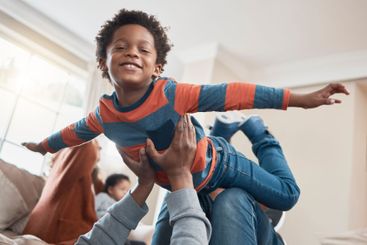 Airplane, joy and black child with father on living room...