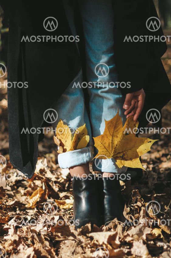 autumn yellow leaves in boots for a girl autumn