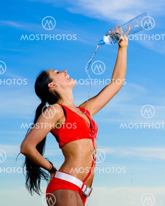 sport girl in red uniform with a bottle of water