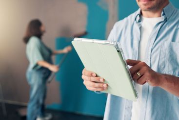 Renovation, tablet and hands of man in home painting for...