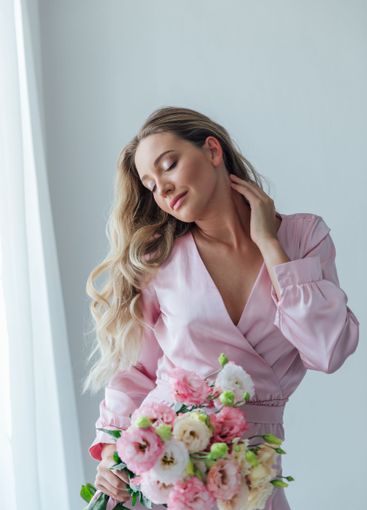 Beautiful fashionable woman in summer pink dress with...