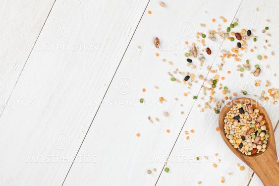 assorted beans in wooden spoon