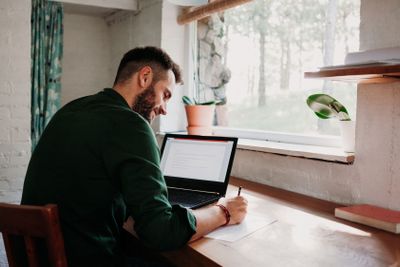 Young casual man working on a laptop