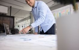 Positive Asian business project analyst man doing...