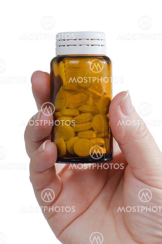 Hands full of pils isolated on white background
