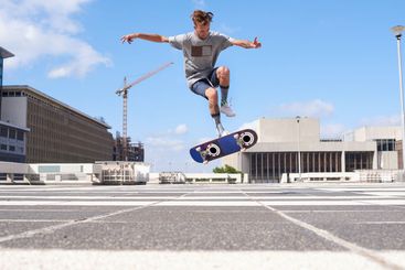Man, jump or flip stunt with skateboard in city for...