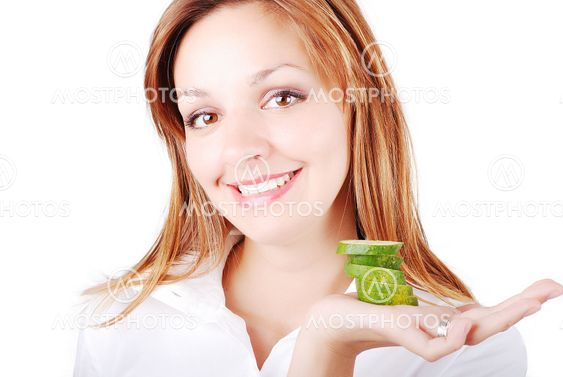 Nice female model with cucumber on palm
