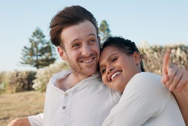 Hug, love and smile with couple in nature for travel...