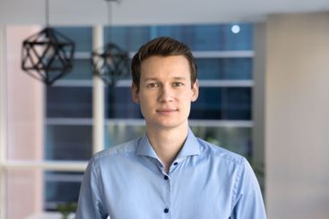 Confident handsome Caucasian businessman standing in office