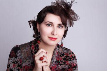 Smiling brunette woman in red hat retro style fashion...