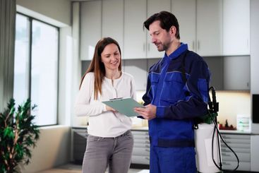 Smiling Pest Control Worker Discusses Invoice
