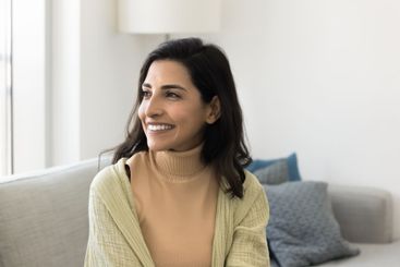 Beautiful Brazilian woman looking into distance with...