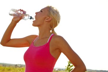 Woman, fitness or drinking water with hydration in...