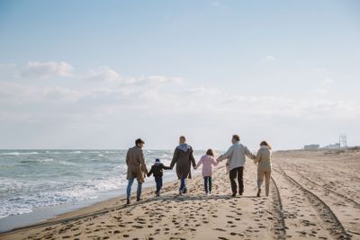 family walking together on seashore