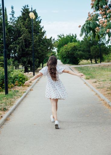 slim fashionable brunette woman in summer white dress...