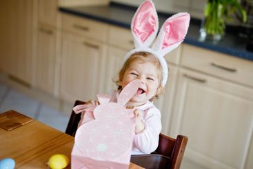 Cute little toddler girl wearing Easter bunny ears...